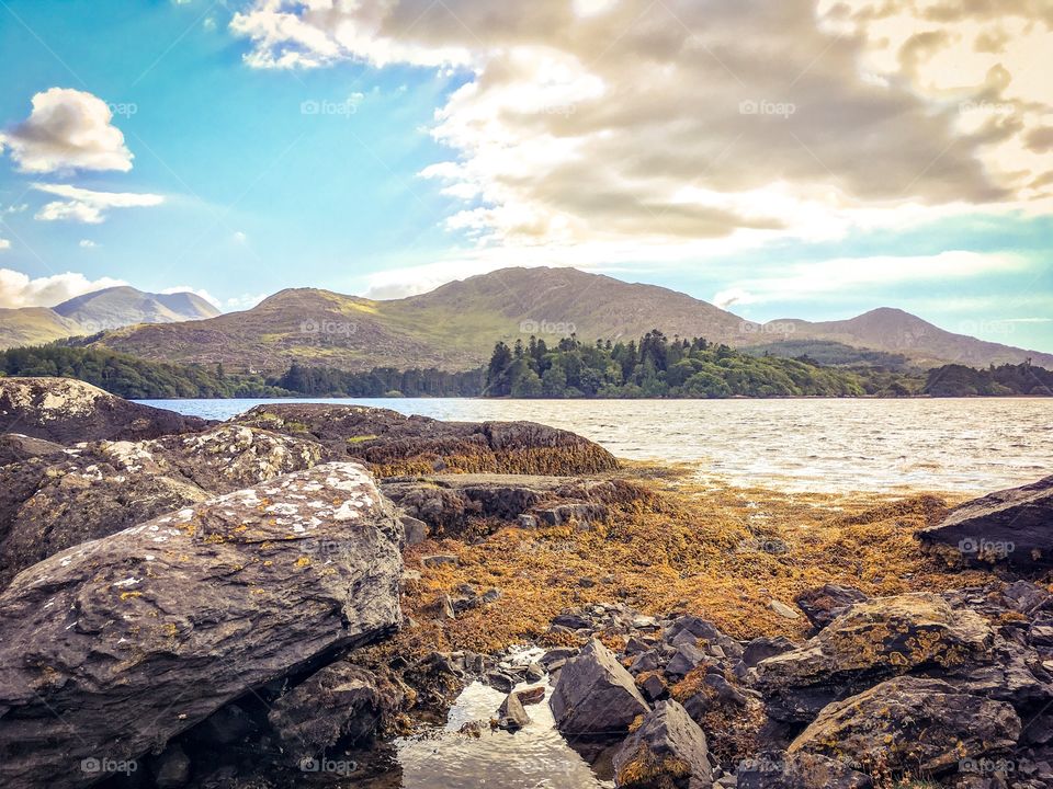 Rugged coastline with mountains in the background. Ring of Beara, Kerry, Ireland. 