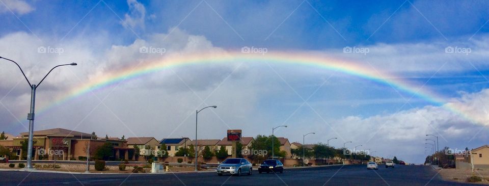 Full rainbow over suburban neighborhood