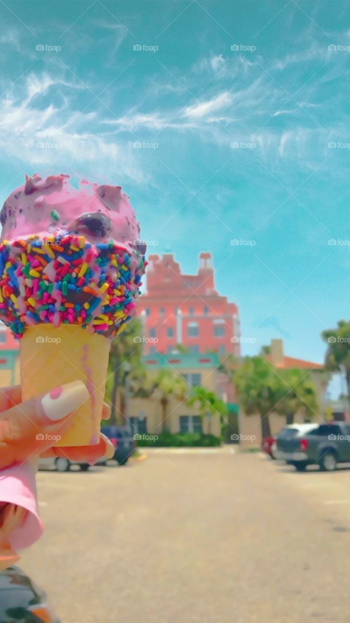 Summer Rainbows. Strawberry Ice cream with sprinkles and blue skies. Melting, yummy, vacationing