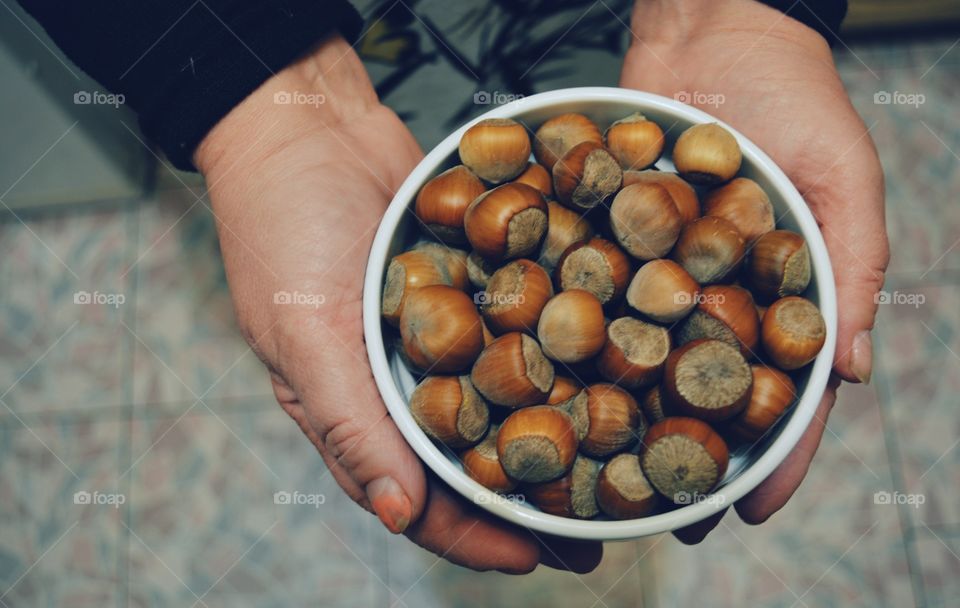 a plate of nuts in their hands