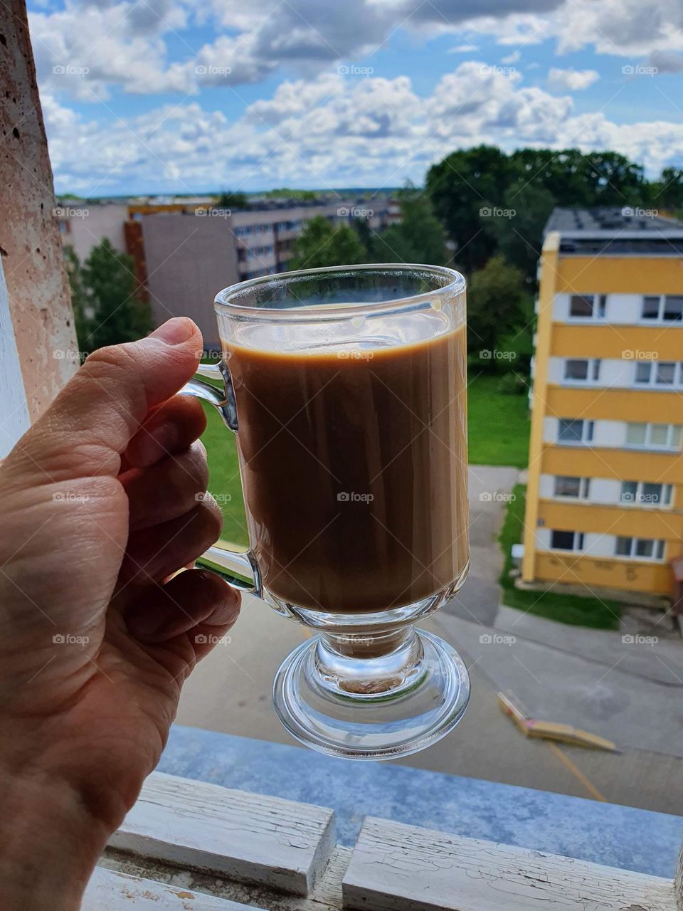 A cup of hot coffee on a sunny day.