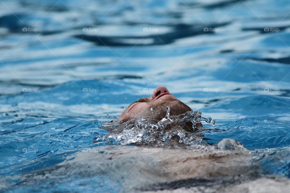 Young man swimming in pool