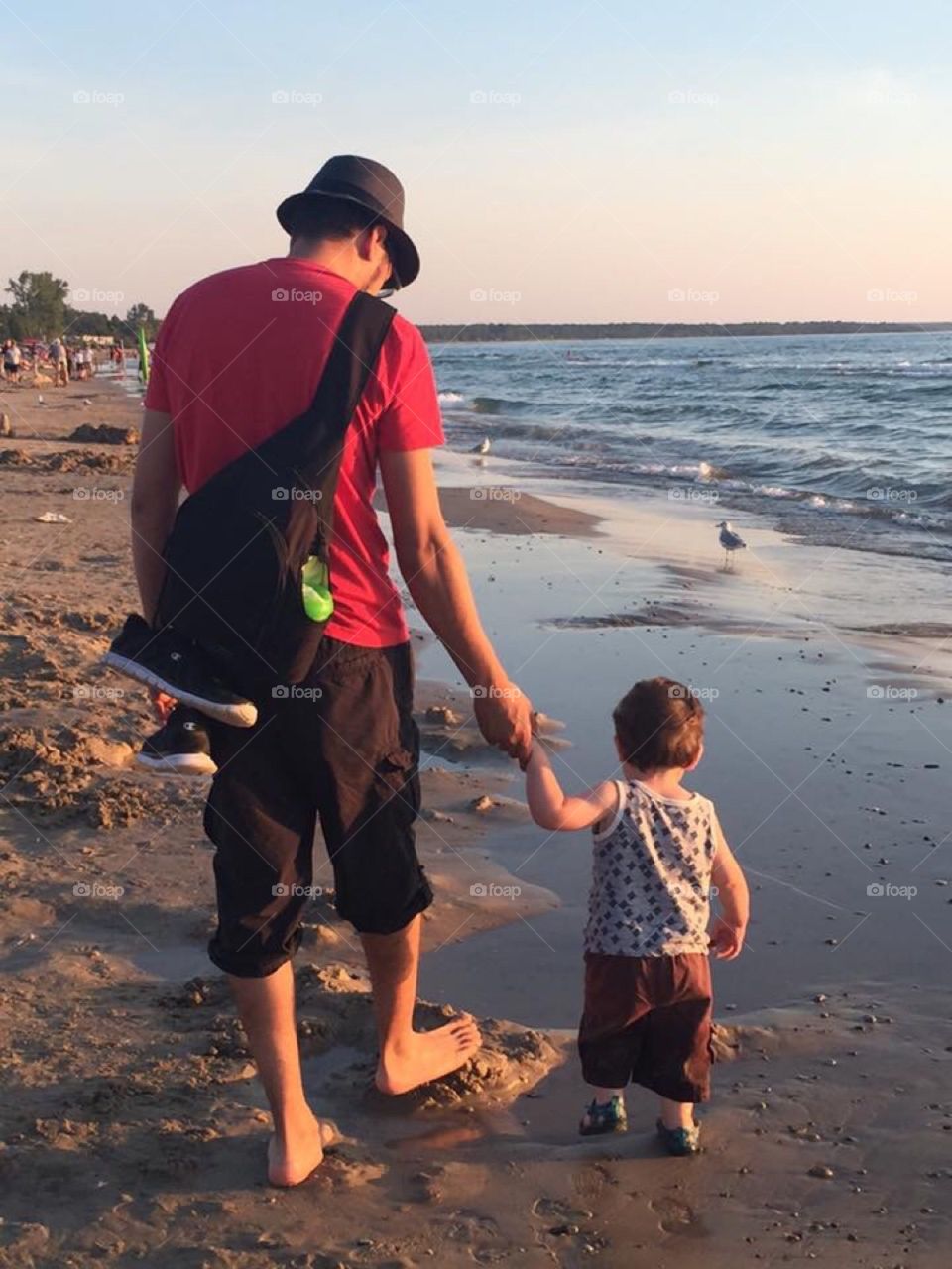 Father and Son on the Beach; summer time at dusk
