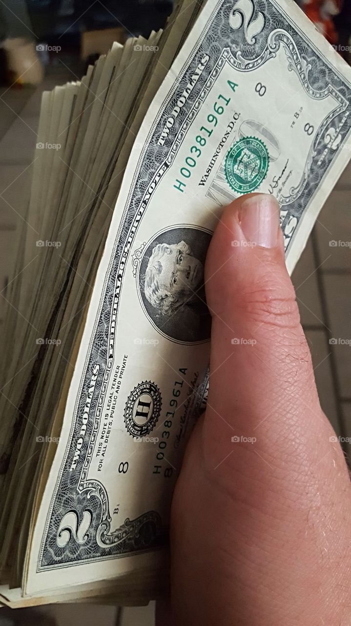 Hand full of $2 bills