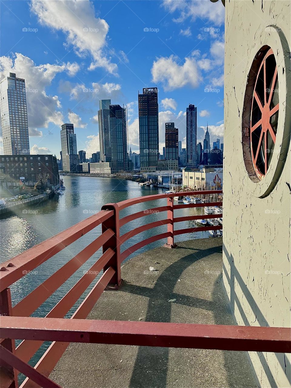 This is the fantastic view from the central outpost of the “Pulaski Bridge” at “Newtown Creek” that connects LIC, Queens to “Greenpoint”, Bklyn. In the far distance we see “Manhattan” incl. the “Empire State Bldg”. 2023. Hypnotic Productions