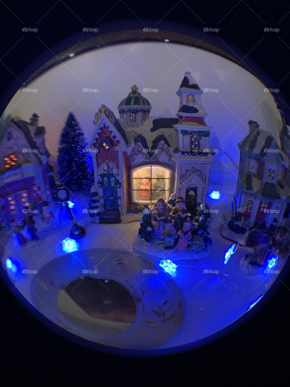 Fisheye lens photography. A Scene of a winter holiday village. Blue LED snowflake lights. Snow scene. 