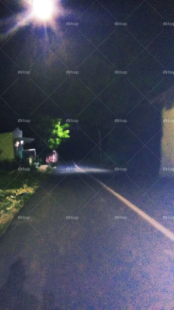 The street atmosphere is quiet and dim