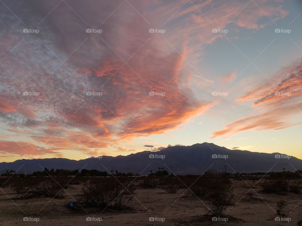sunset over the mountains and desert in Coachella Valley California, pink sky