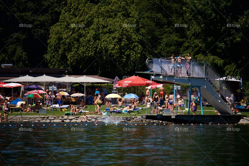 People Having Fun At Lake In Summer