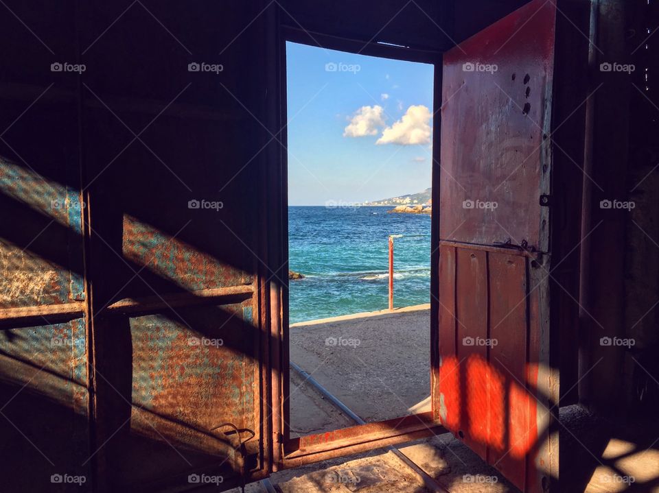 Bright light at the sea through the door 