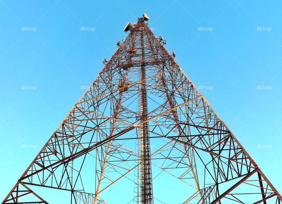 telecommunications tower against beautiful clear blue sky.