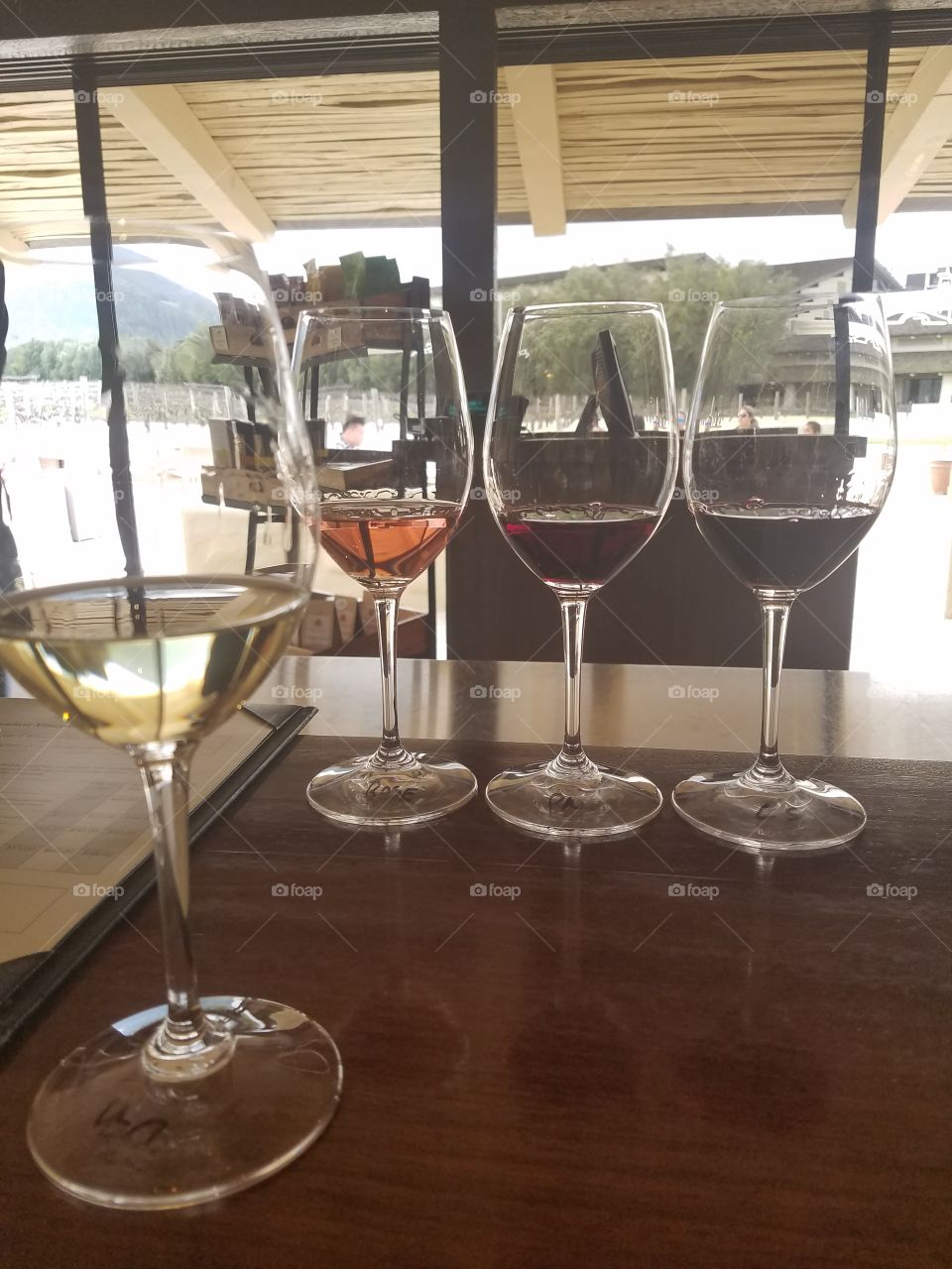 Bright flight of four wines in wine glasses at a winery