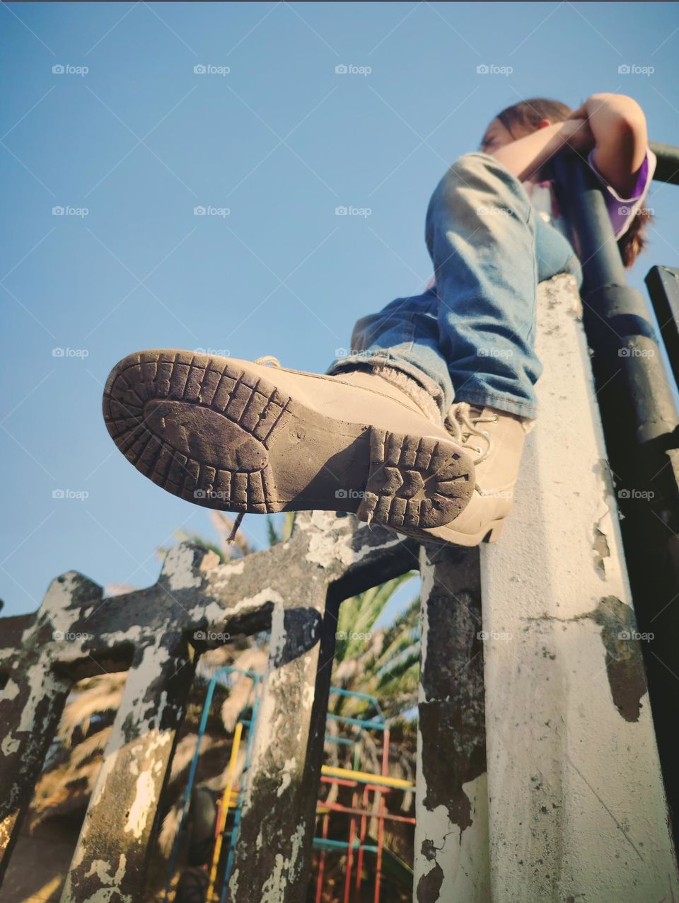 Child sitting on wall