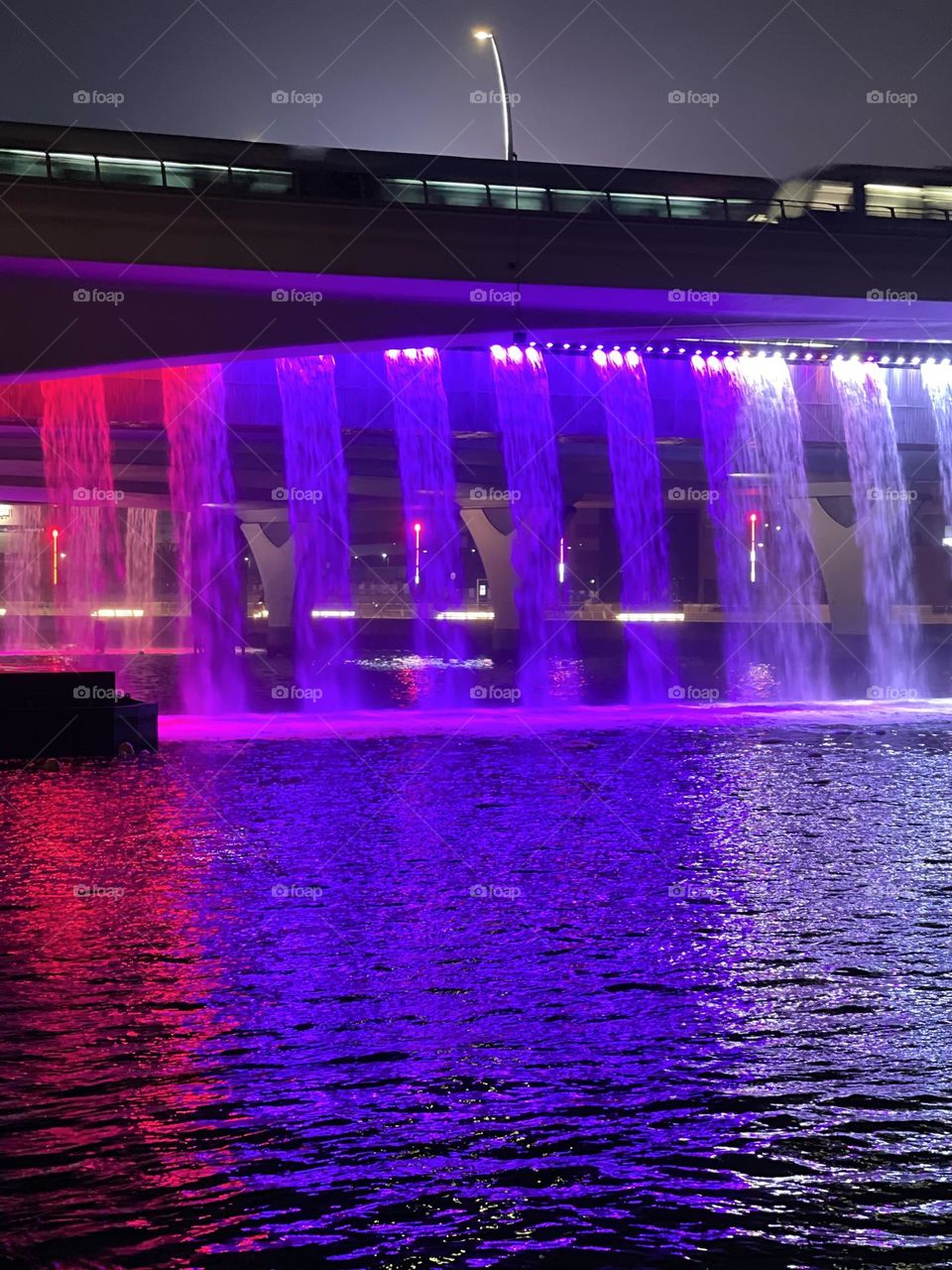 Metro train over the purple water