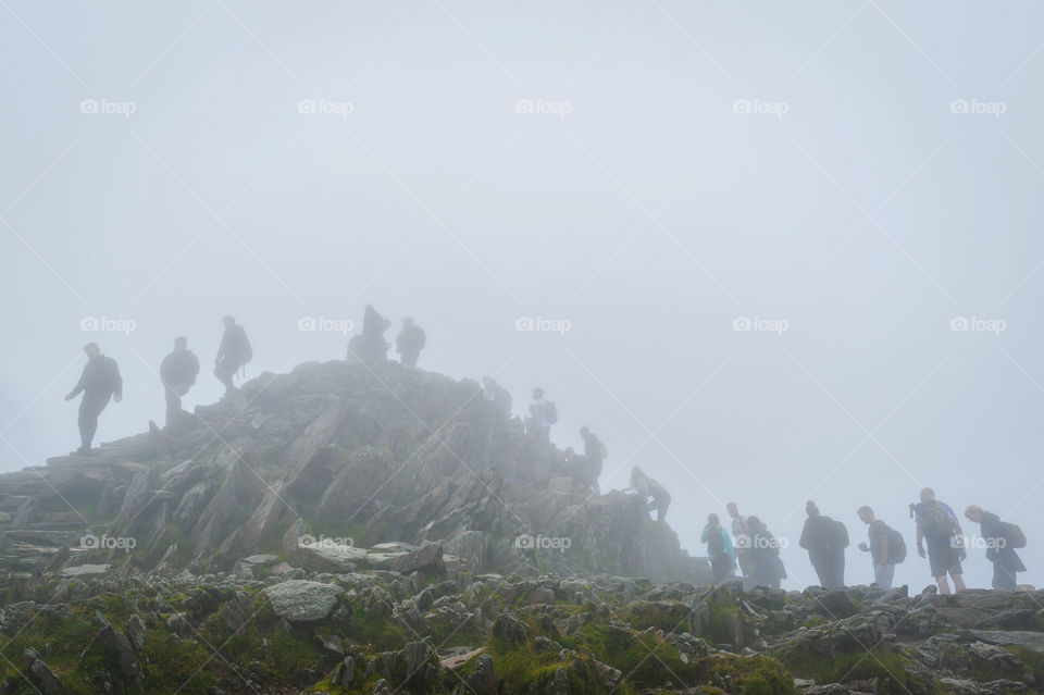 Mount Snowdon. People queueing at the top to take a selfie. Social distancing in July 2020 during national lockdown. Snowdonia National Park. Wales. UK.