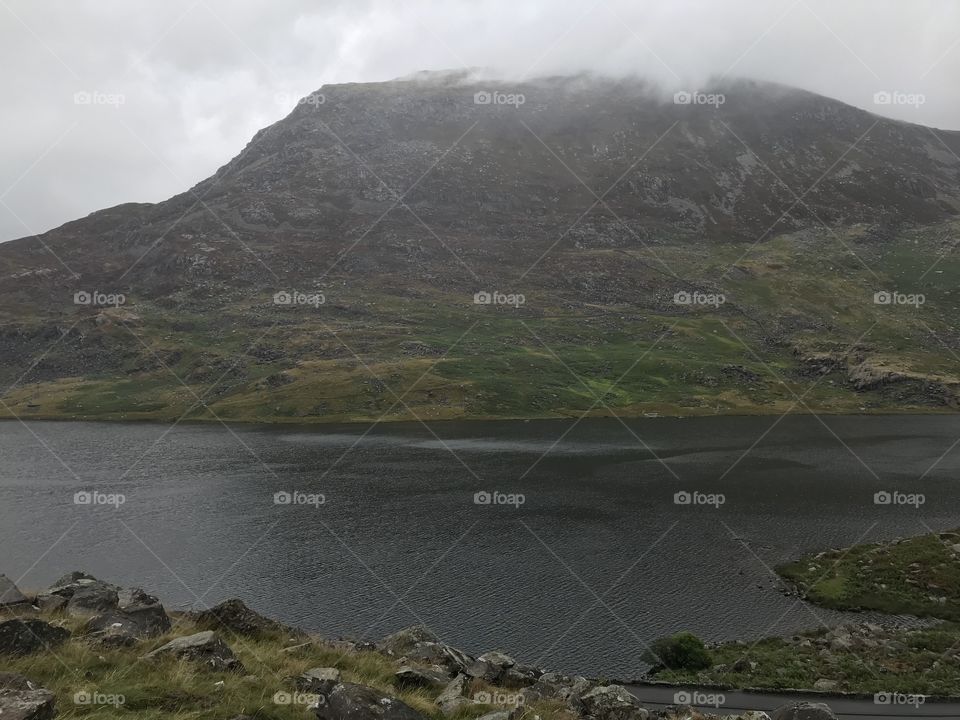Rain sets in over the dark lake in the north