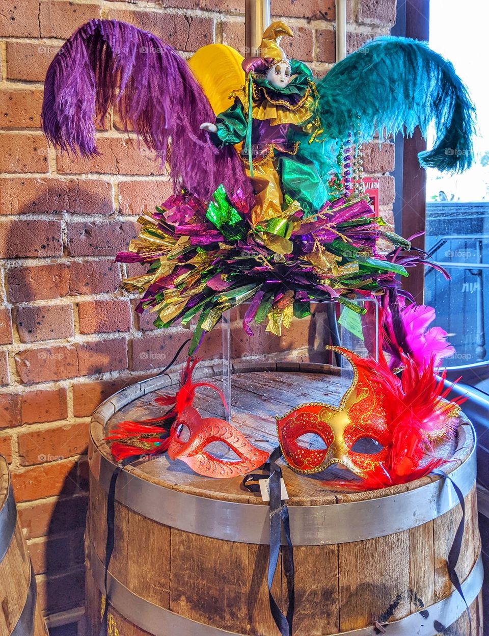 colorful and feathered masquerade, carnival, Mardi Gras and party masks on a barrel