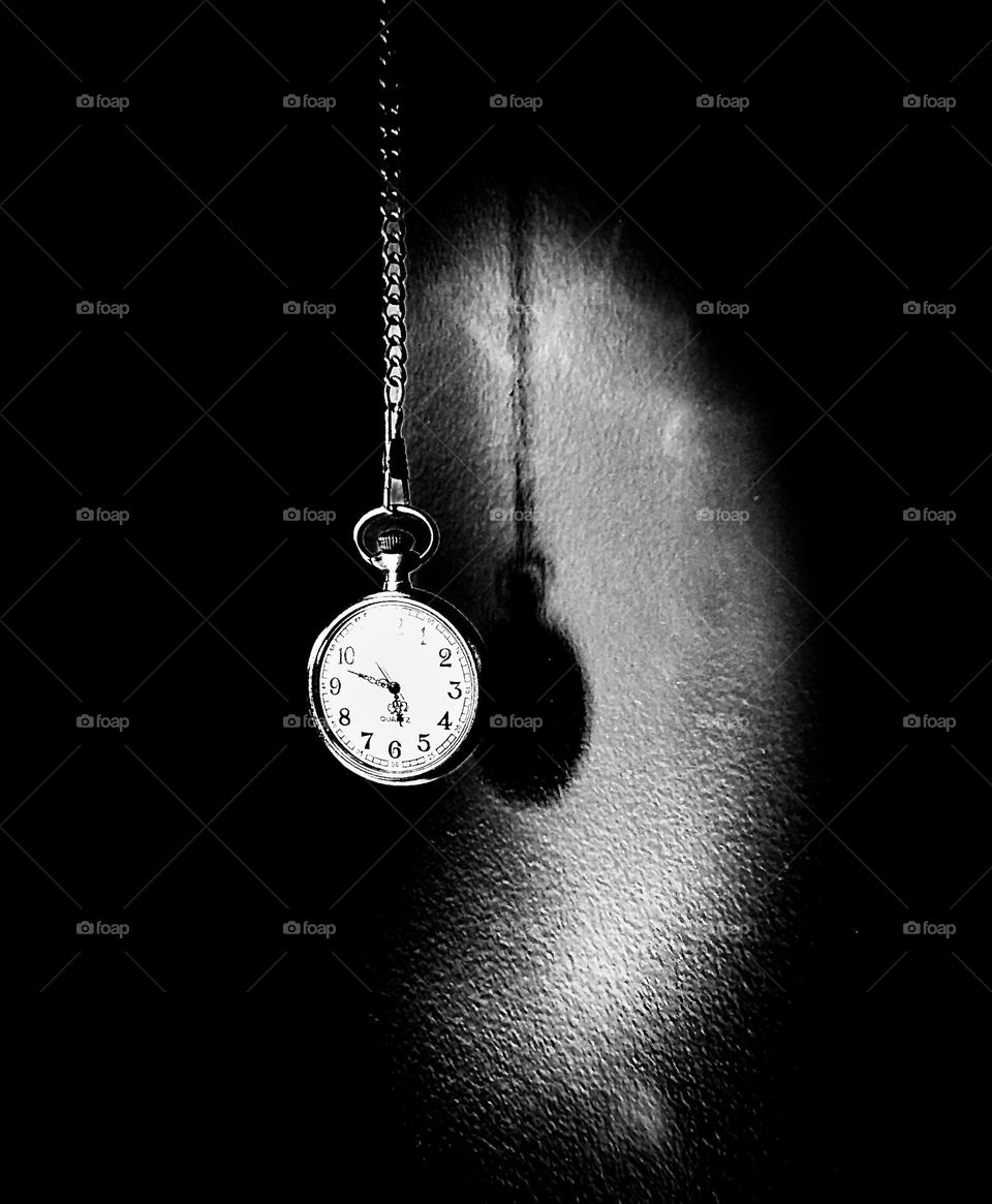 The shadow of Time is history repeating itself. A prop stopwatch with smokey, shadow bouncing off a wall painted in the color of Cracked Pepper