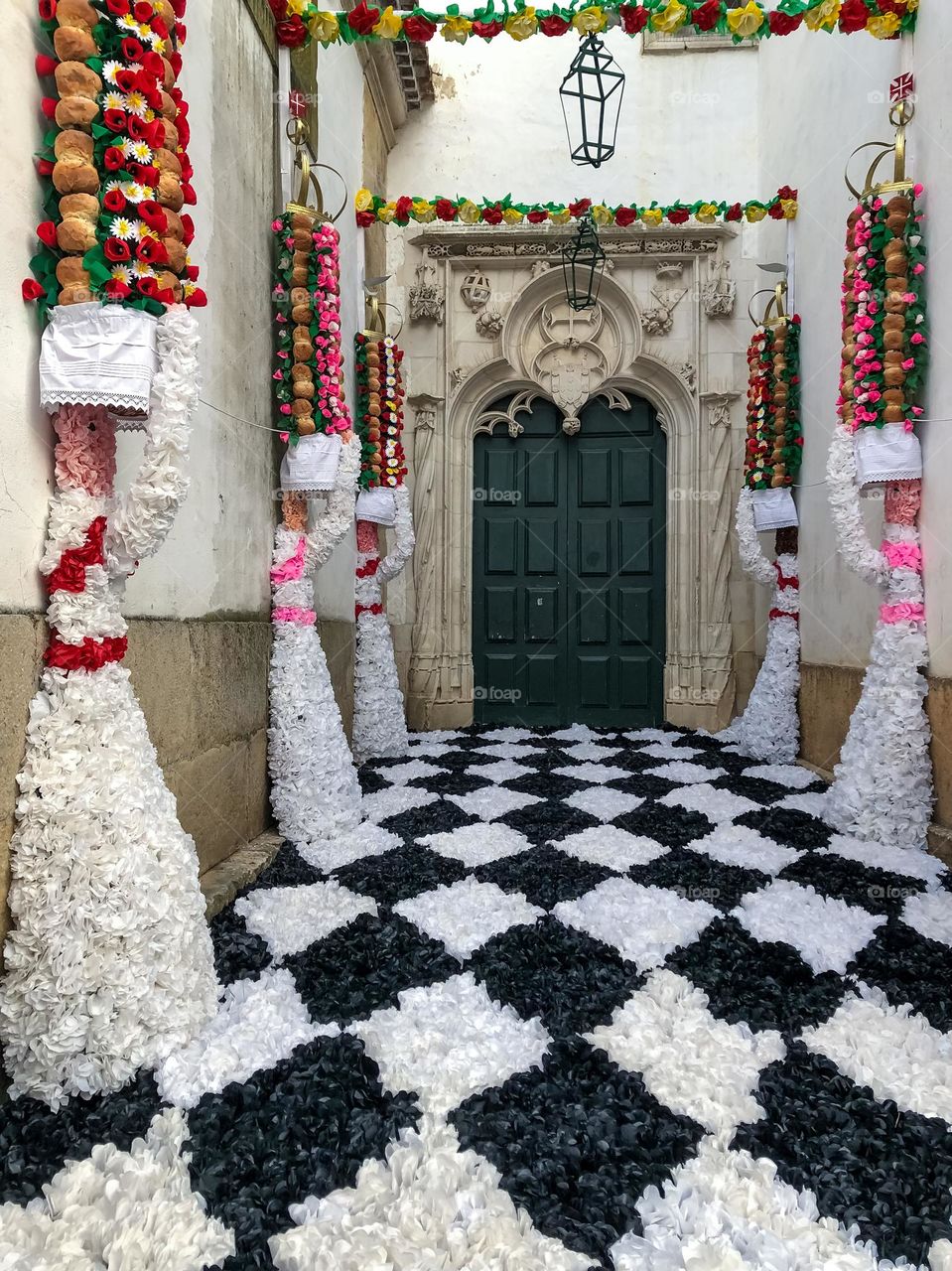 The side entrance to a church carefully decorated with paper flowers for the Festa Dos Tabuleiros in Tomar
