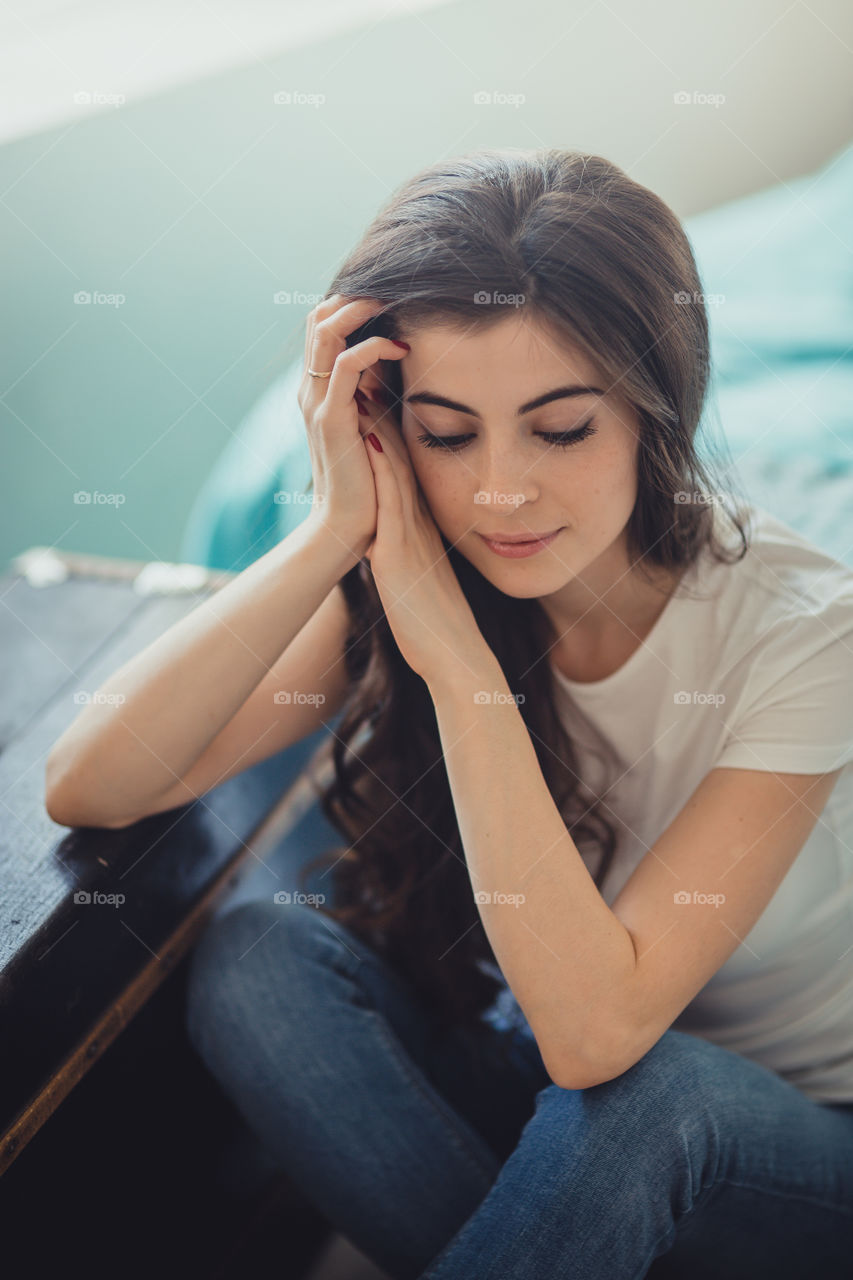 Beautiful young woman at home in daylight 