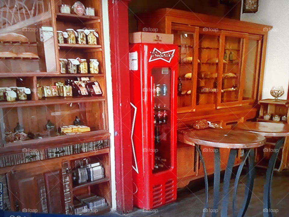 Place where we take our leisure with freezer in red color and wooden shelves excellent place for late afternoon.