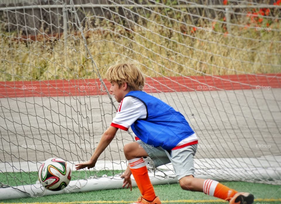 Youth Soccer. Young Boy Playing Goalie
