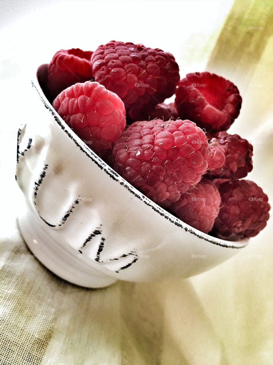 Close-up of raspberries on bowl