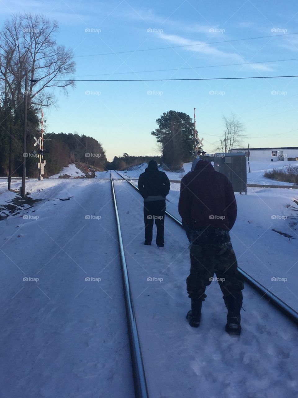 Kids walking down train tracks