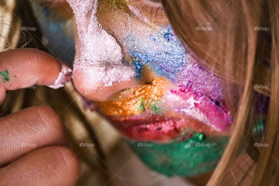 A child wearing glitter makeup