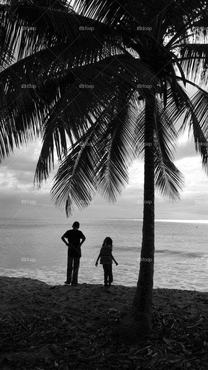 Boy and girl watching at the sea