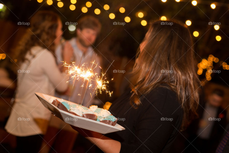 Serve with Spaklers. Event photography; serving miniature cupcakes with sparklers to celebrate!