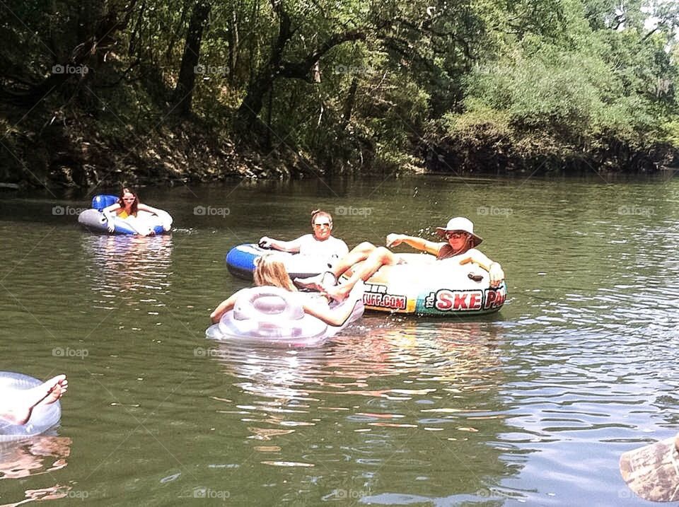 Women floating on inflatable ring