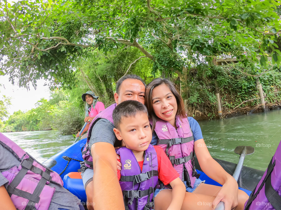 Tourists on the inflatable boat floating on the water in the river The flow of Kaeng Krachan Dam at Phetchaburi in Thailand. June 10, 2019