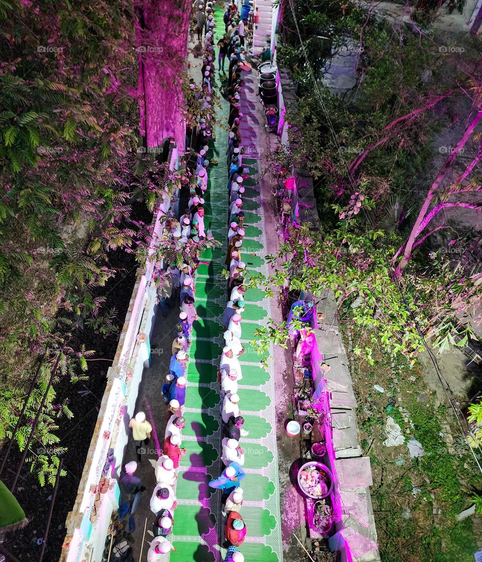 people standing together after iftar for namaaz