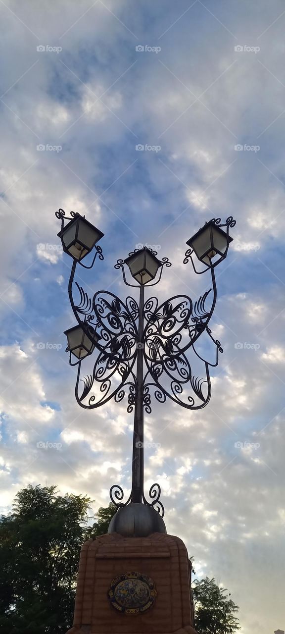Farol clásico de forja cielo y nubes