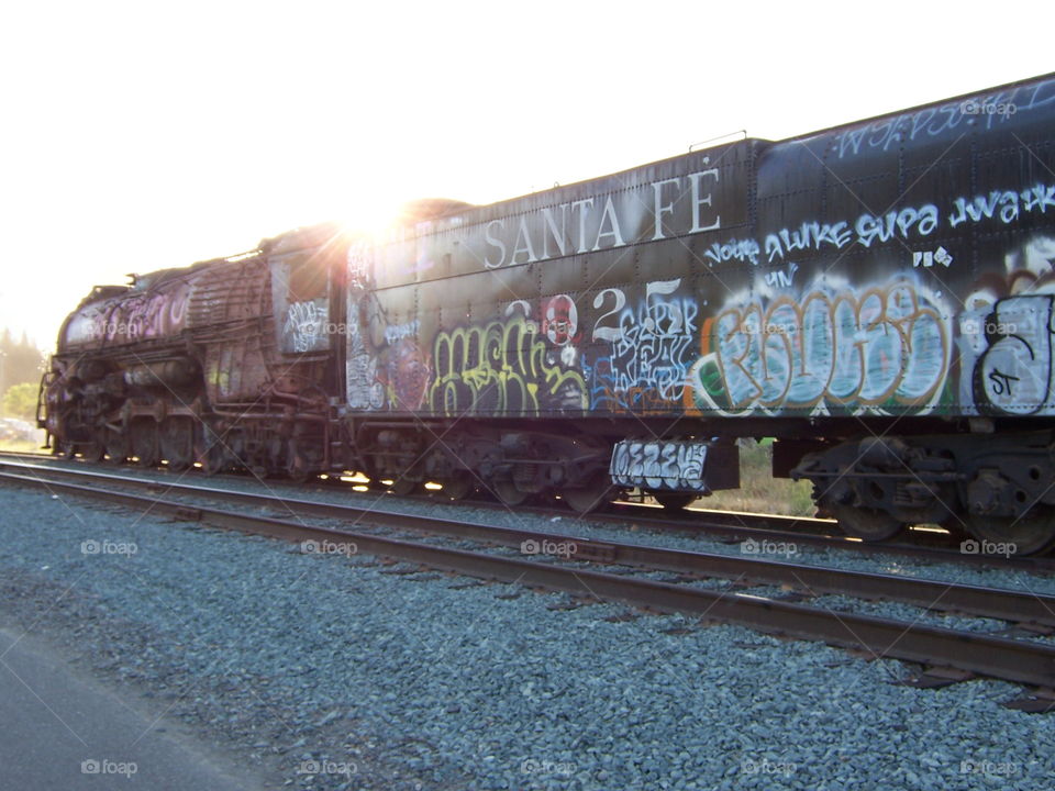 Sunrise over old Santa Fe train. Riding along the railroad tracks