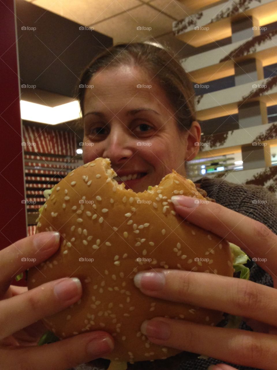 Woman holding burger in hand