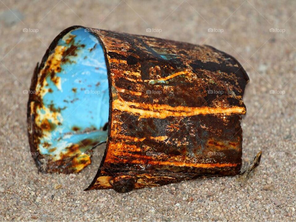 rusted pot of color on the beach