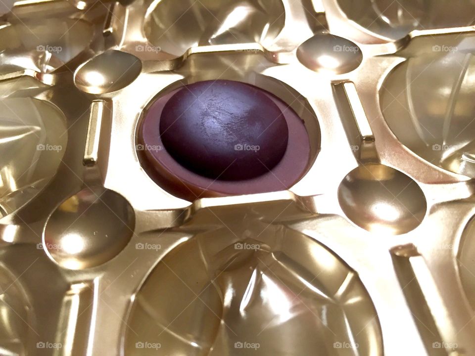 Piece of chocolate in gold wrapping