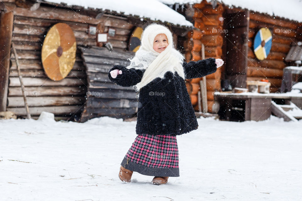 Cute kid in russian village at winter