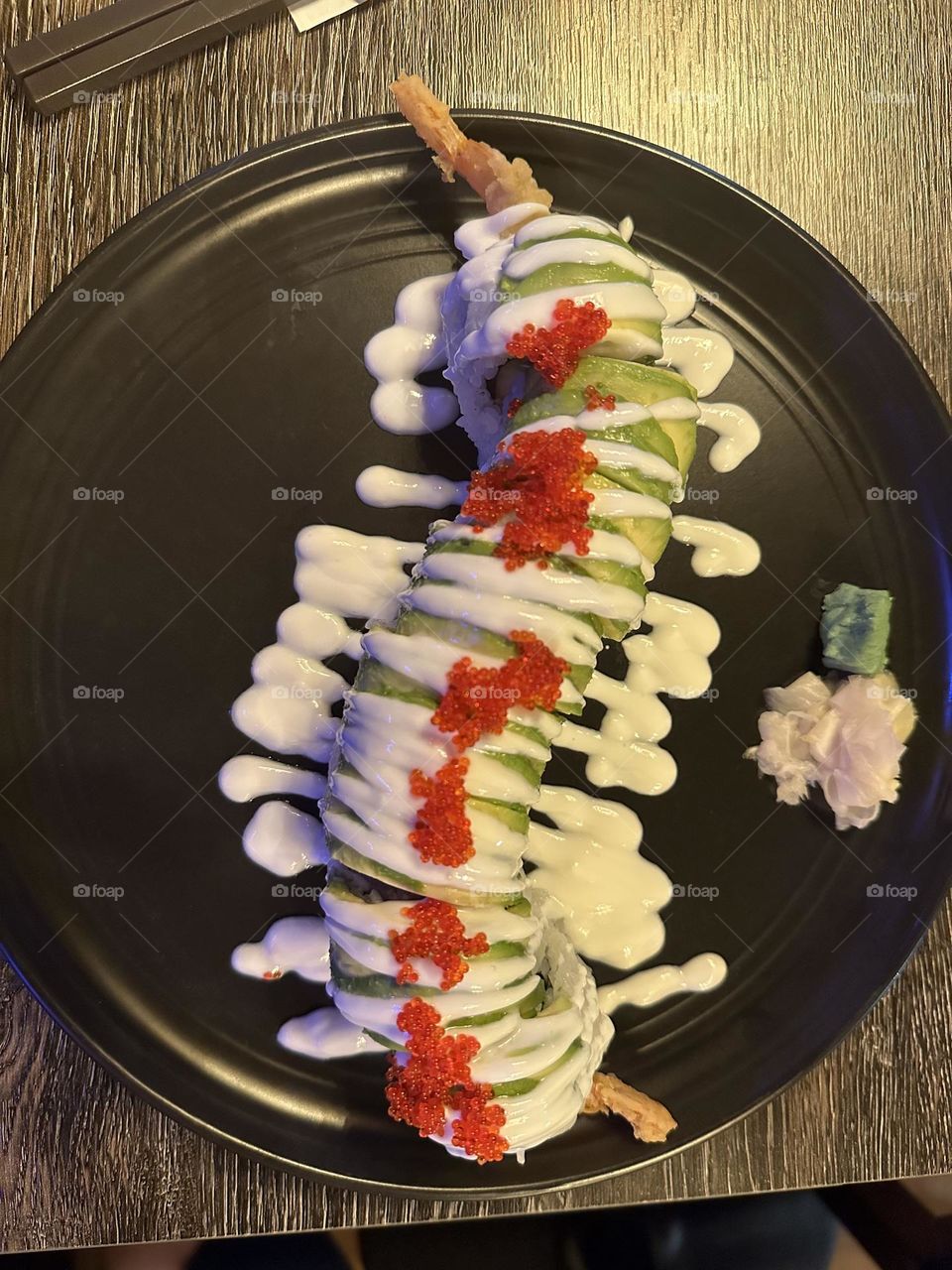 Sushi on a black plate