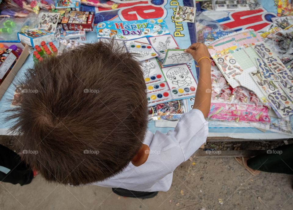 Colorful local life , Student is choosing toy at U bien , the longest wooden bridge in Mandalay Myanmar