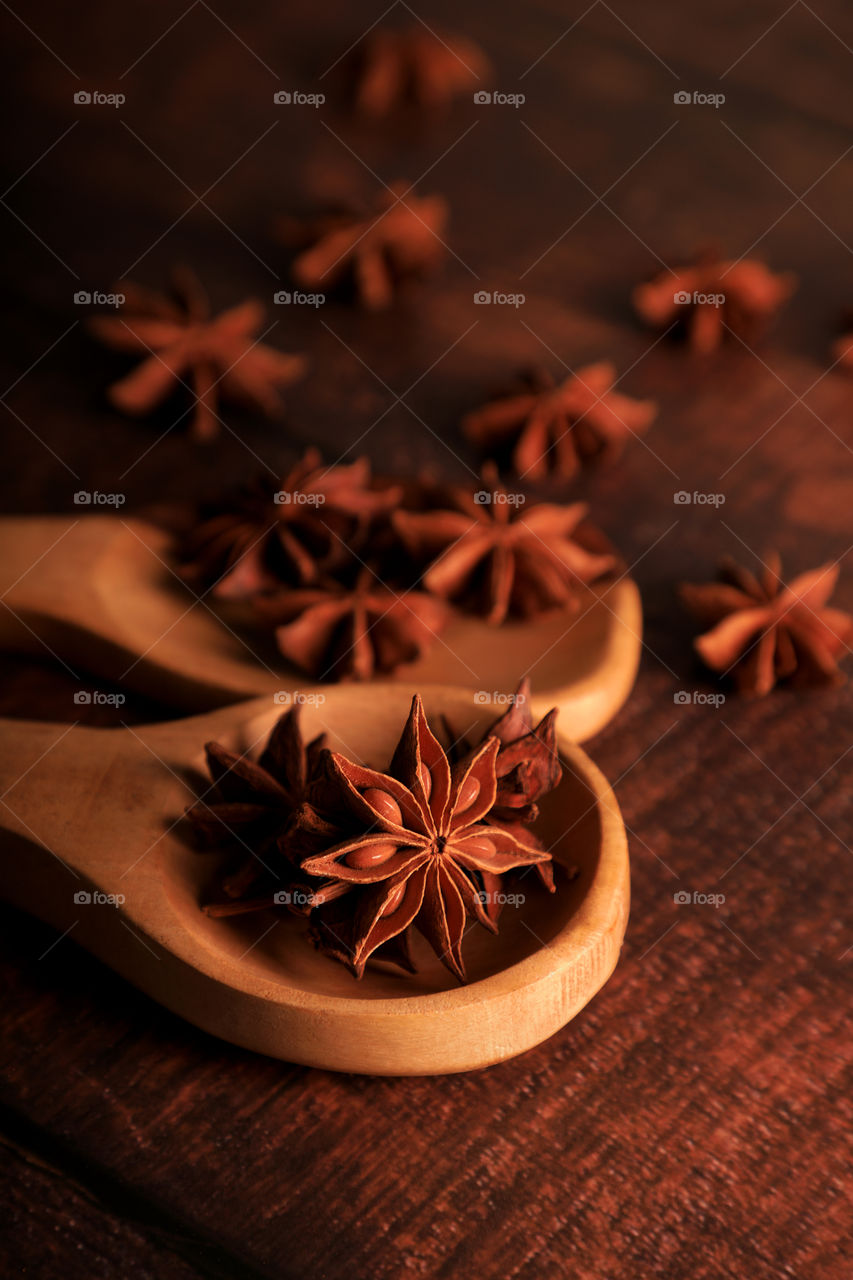 Indian spice star anise on a wooden spatula