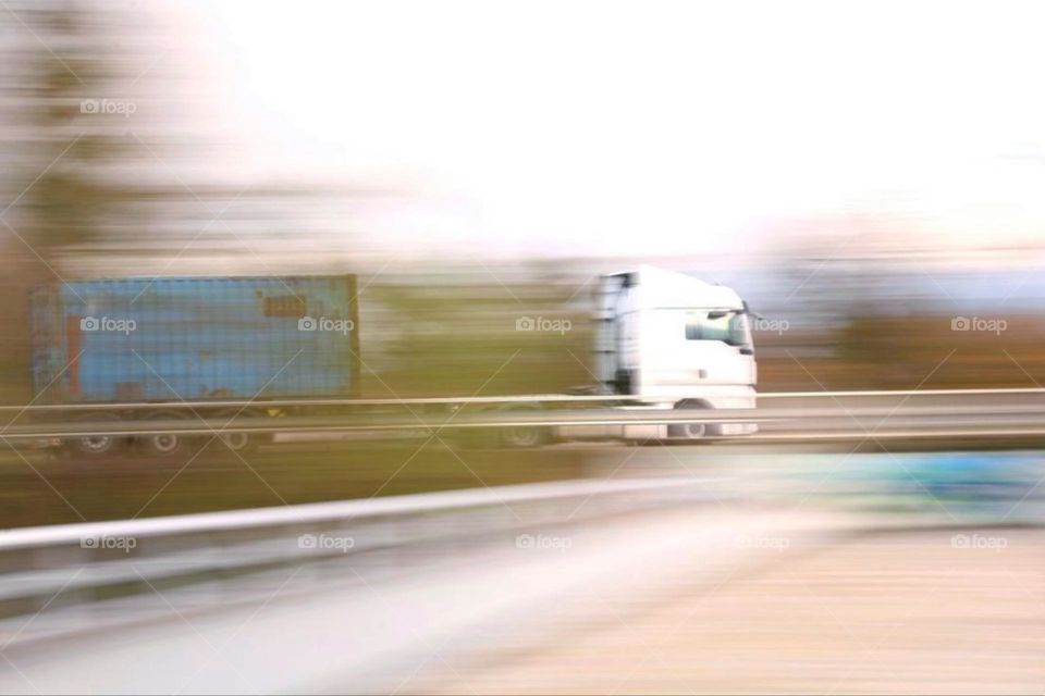 A truck is speeding with goods on the highway