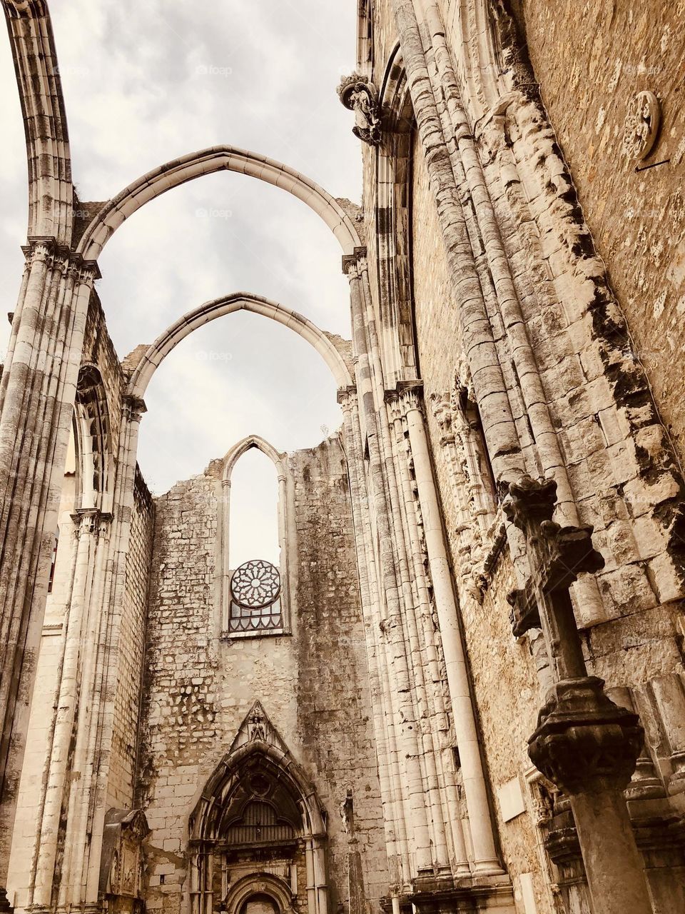 Low angle view of old Lisbon church without roof, old building remains, Portuguese architecture, Carmo covent 