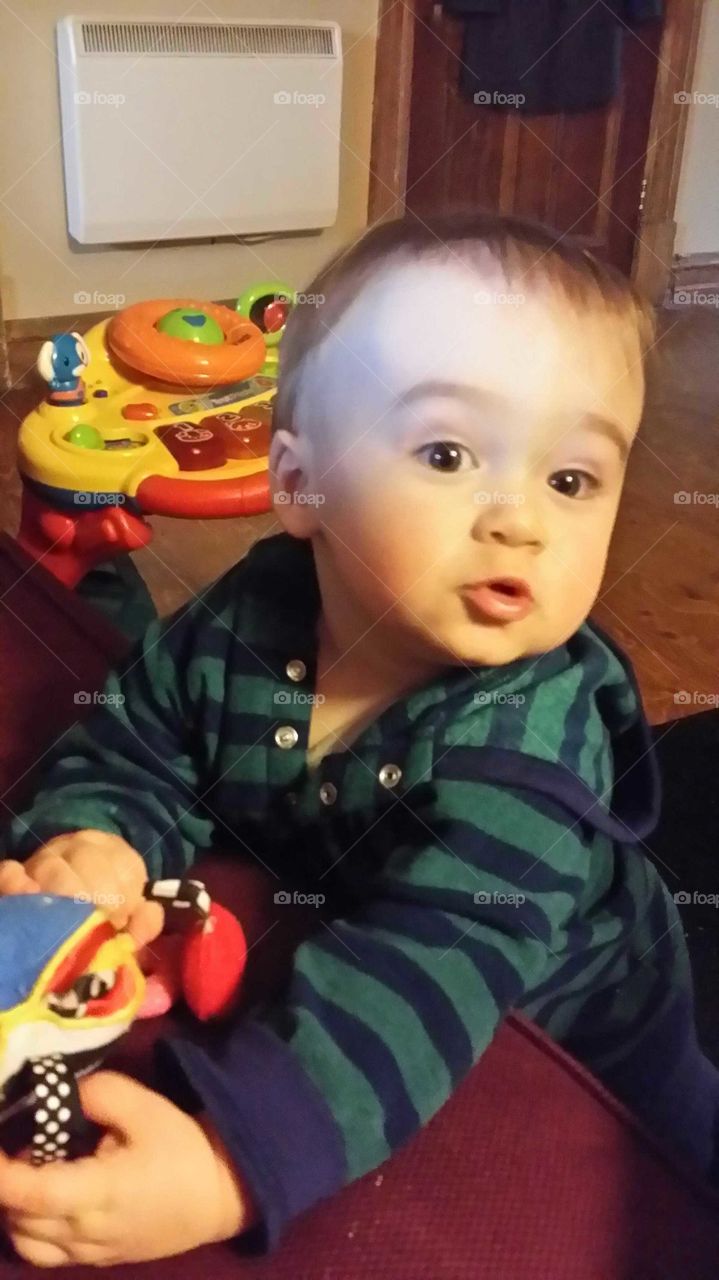 Baby makes a cute face while playing with toys!