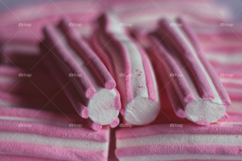 Pink white red drop marshmallow sweet candy snack pastel colour food closeup background strip sugar delicious dessert 