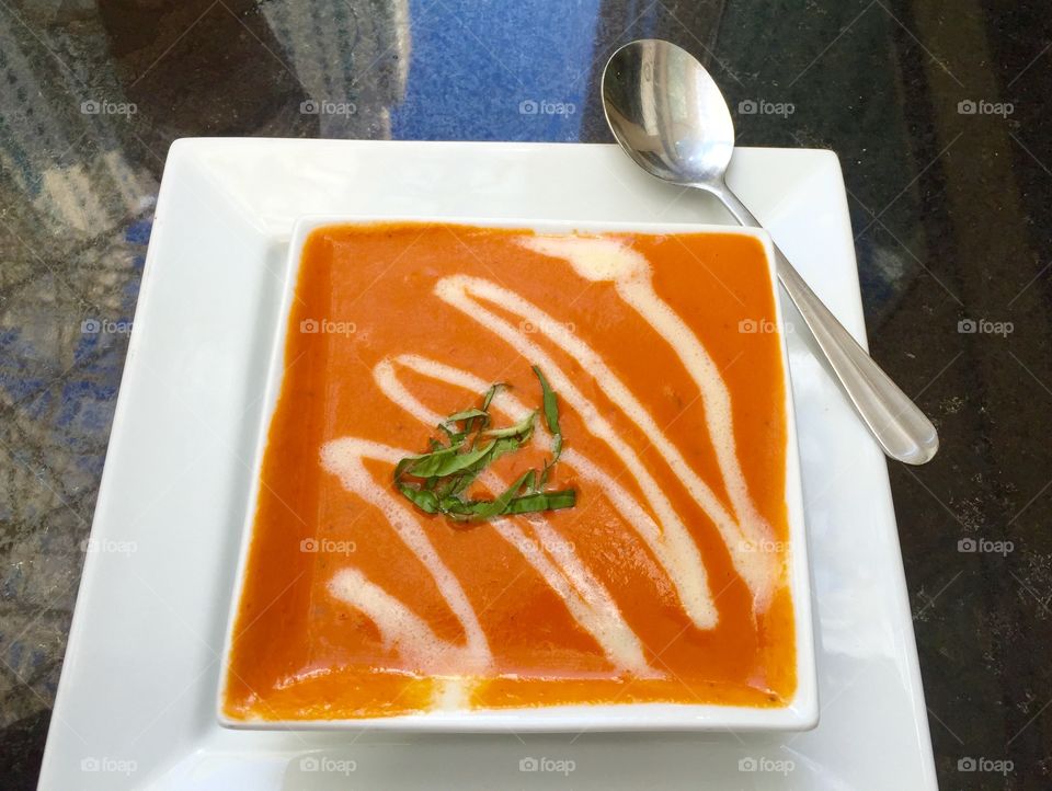 Tomato soup. Tomato bisque served in a square bowl