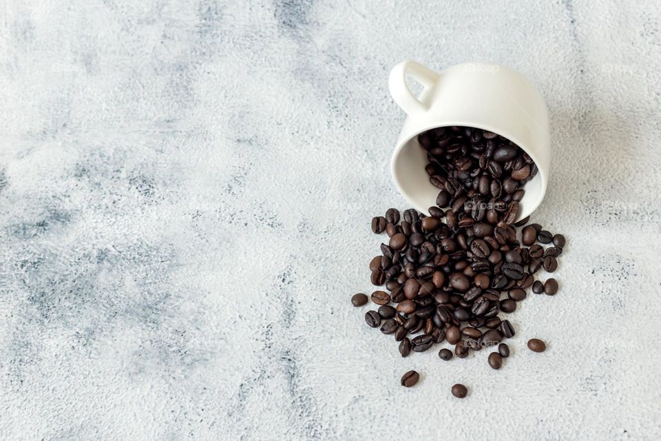 Roasted coffee beans in white cup