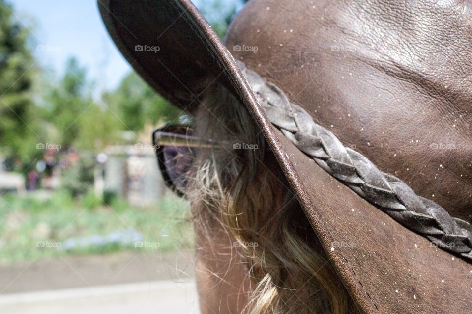 Blonde hair middle aged woman wearing leather cowboy hat side view head shot profile